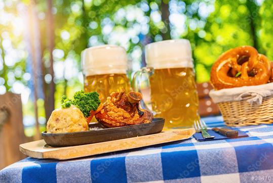 Schweinshaxe, traditional Bavarian cuisine with roasted ham hock (pork knuckle) with potato dumpling, brezen and beer mug on a table at beer garden  : Stock Photo or Stock Video Download rcfotostock photos, images and assets rcfotostock | RC Photo Stock.: