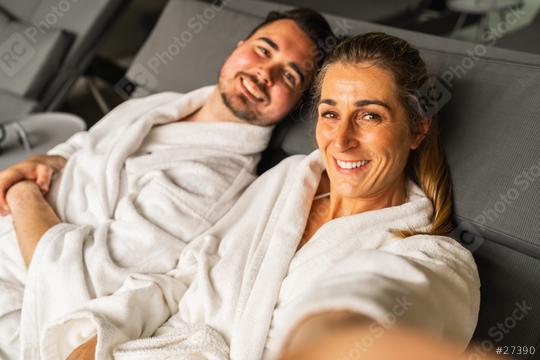 Selfie of smiling couple in white spa robes reclining and looking at camera in a hotel resort  : Stock Photo or Stock Video Download rcfotostock photos, images and assets rcfotostock | RC Photo Stock.: