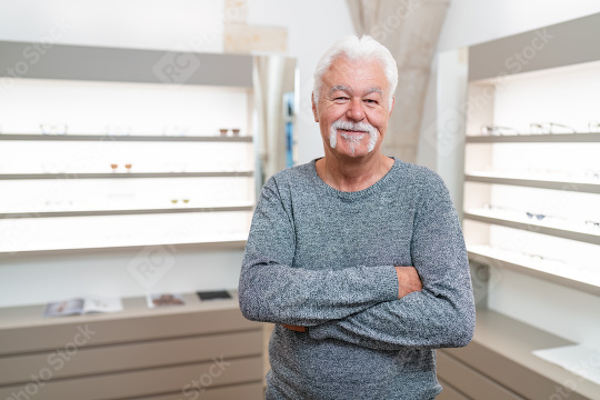 Senior customer with white hair smiling. He has his arms crossed  : Stock Photo or Stock Video Download rcfotostock photos, images and assets rcfotostock | RC Photo Stock.: