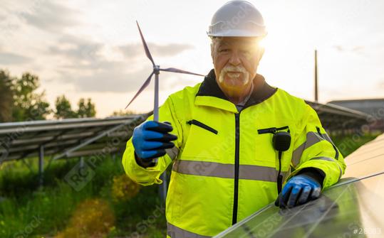 Senior engineer holding a wind turbine model at a solar photovoltaic panel system at sunset. Alternative energy ecological concept.  : Stock Photo or Stock Video Download rcfotostock photos, images and assets rcfotostock | RC Photo Stock.: