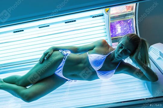 sexy woman in a bathing suit sunbathing in a solarium under the ultraviolet rays  : Stock Photo or Stock Video Download rcfotostock photos, images and assets rcfotostock | RC Photo Stock.: