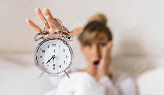 Shocked young woman waking up holding her alarm clock in the morning. Late and Time is running concept image  : Stock Photo or Stock Video Download rcfotostock photos, images and assets rcfotostock | RC Photo Stock.: