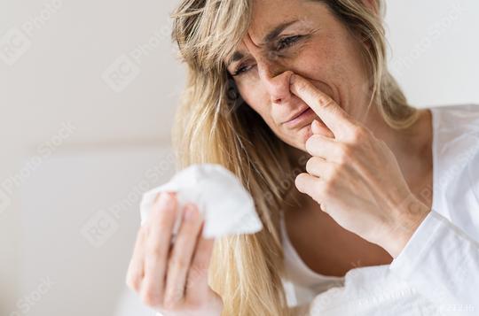 Sick woman Picking his nose. Upset ill european lady sits  in bed, blowing and picks her nose using paper napkin tissue. Cold And Flu Concept  : Stock Photo or Stock Video Download rcfotostock photos, images and assets rcfotostock | RC Photo Stock.: