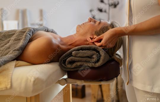 Side view of a massage therapist doing an ear massage for a relaxed female client
  : Stock Photo or Stock Video Download rcfotostock photos, images and assets rcfotostock | RC Photo Stock.: