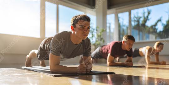 Side view of a muscular people doing planking exercises in gym on a yoga mat  : Stock Photo or Stock Video Download rcfotostock photos, images and assets rcfotostock | RC Photo Stock.: