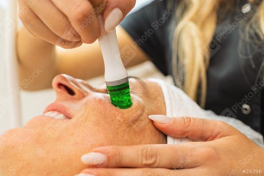 Side view of woman receiving aquafacial therapy on cheek at beau  : Stock Photo or Stock Video Download rcfotostock photos, images and assets rcfotostock | RC Photo Stock.: