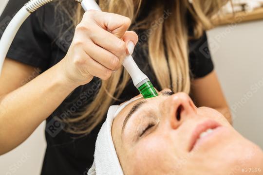 Side view of woman receiving aquafacial therapy on forehead at beauty spa or cosmetology salon.   : Stock Photo or Stock Video Download rcfotostock photos, images and assets rcfotostock | RC Photo Stock.: