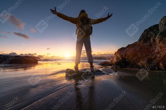 Silhouette of a person with arms raised standing on a rock at a beach during sunset with vibrant sky. Travel and Freedom Concept image  : Stock Photo or Stock Video Download rcfotostock photos, images and assets rcfotostock | RC Photo Stock.: