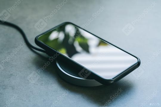 smartphone wireless charging on induction charger. Wireless charger  : Stock Photo or Stock Video Download rcfotostock photos, images and assets rcfotostock | RC Photo Stock.: