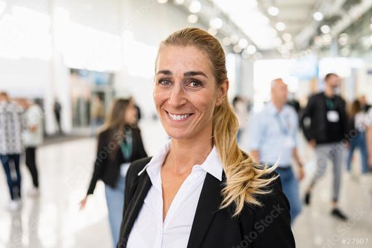 smiling businesswoman at a trade fair holding tablet  : Stock Photo or Stock Video Download rcfotostock photos, images and assets rcfotostock | RC Photo Stock.: