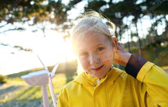 Smiling child holding wind turbine model at sunset at the forest smiling at camera. Energy Production with clean and Renewable Energy concept image  : Stock Photo or Stock Video Download rcfotostock photos, images and assets rcfotostock | RC Photo Stock.: