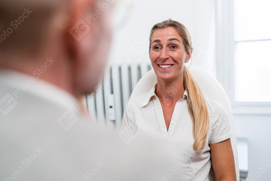 Smiling female patient in conversation with optometrist during e  : Stock Photo or Stock Video Download rcfotostock photos, images and assets rcfotostock | RC Photo Stock.: