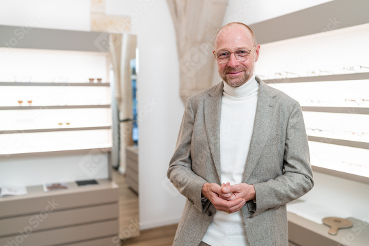 smiling optician with glasses in a store. He has his hands clasp  : Stock Photo or Stock Video Download rcfotostock photos, images and assets rcfotostock | RC Photo Stock.: