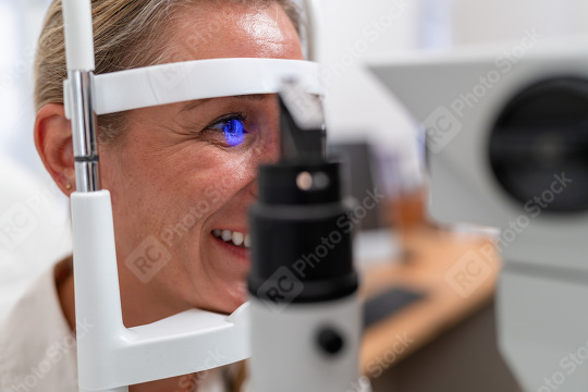 Smiling woman during eye exam with retinal reflection visible us  : Stock Photo or Stock Video Download rcfotostock photos, images and assets rcfotostock | RC Photo Stock.: