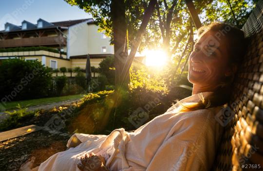 Smiling woman enjoying the morning sun on a wicker swing in a garden at sap wellness resort hotel  : Stock Photo or Stock Video Download rcfotostock photos, images and assets rcfotostock | RC Photo Stock.: