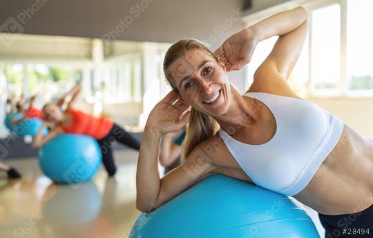 smiling woman flexing abdominal muscles with exercise ball in gym. Healthy sports lifestyle, Fitness, Healthy concept.  : Stock Photo or Stock Video Download rcfotostock photos, images and assets rcfotostock | RC Photo Stock.: