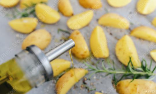 spill oil out of can on raw potato wedges on baking tray   : Stock Photo or Stock Video Download rcfotostock photos, images and assets rcfotostock | RC Photo Stock.: