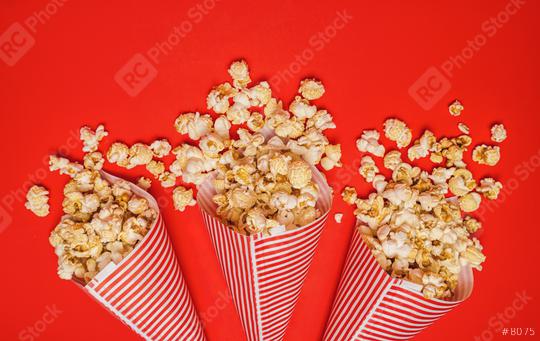 Spilled popcorn in paper bags on a red background, cinema, movies  entertainment and carnival concept image Stock Photo and Buy images at  rcfotostock this photo and find more royalty-free stock photos from