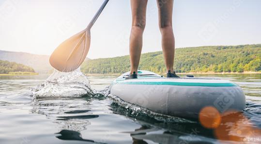 Stand up paddle boarding on a quiet lake at summer, close-up of legs  : Stock Photo or Stock Video Download rcfotostock photos, images and assets rcfotostock | RC Photo Stock.: