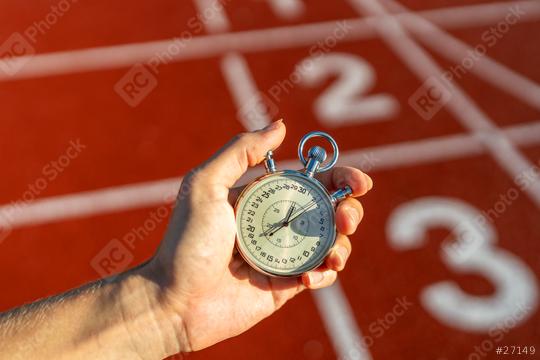 Stopwatch in hand, track numbers background, timing, sports, competition, measuring performance  : Stock Photo or Stock Video Download rcfotostock photos, images and assets rcfotostock | RC Photo Stock.: