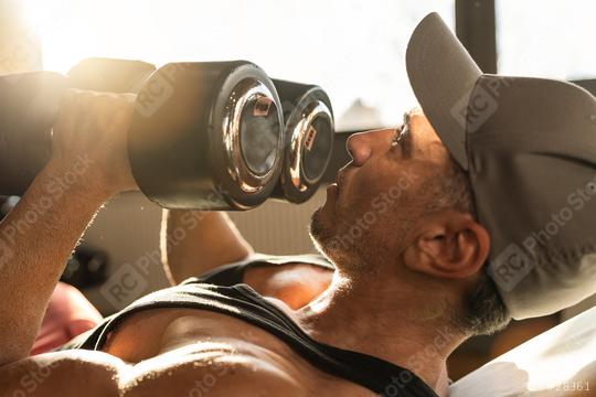 Strong man, bodybuilder exercising with dumbbells in a gym  : Stock Photo or Stock Video Download rcfotostock photos, images and assets rcfotostock | RC Photo Stock.: