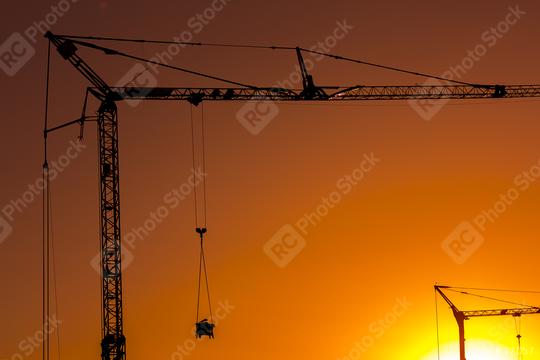 Sunset behind a Construction site silhouette building with cranes  : Stock Photo or Stock Video Download rcfotostock photos, images and assets rcfotostock | RC Photo Stock.: