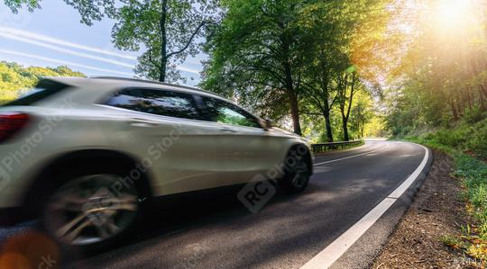SUV car drives Long a Curvy Forest Road In Alpine Mountains at sunrise  : Stock Photo or Stock Video Download rcfotostock photos, images and assets rcfotostock | RC Photo Stock.: