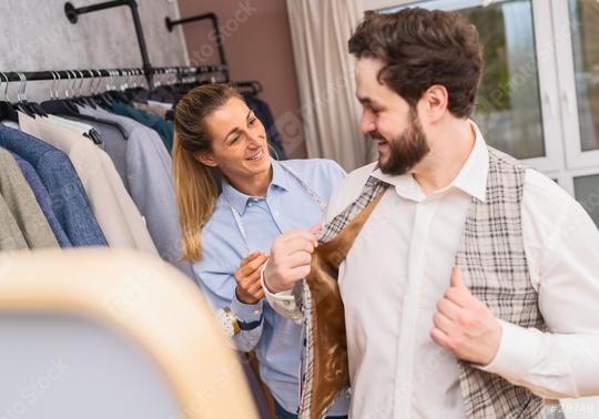 Tailor adjusting a checkered jacket on a client in a boutique  : Stock Photo or Stock Video Download rcfotostock photos, images and assets rcfotostock | RC Photo Stock.: