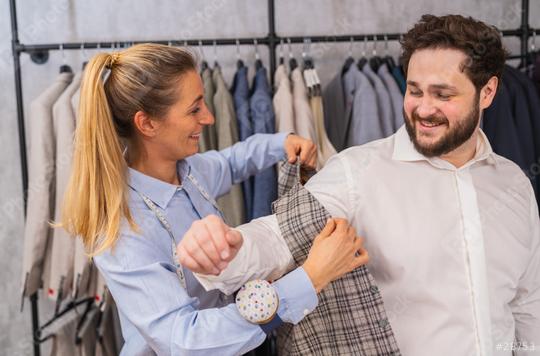 Tailor adjusting a checkered vest on a smiling client in a suit shop  : Stock Photo or Stock Video Download rcfotostock photos, images and assets rcfotostock | RC Photo Stock.: