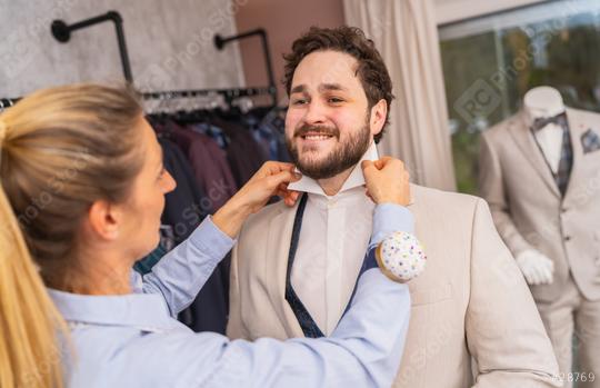 Tailor adjusting a man