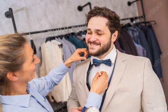 Tailor adjusting a tie for a happy client in a suit boutique  : Stock Photo or Stock Video Download rcfotostock photos, images and assets rcfotostock | RC Photo Stock.: