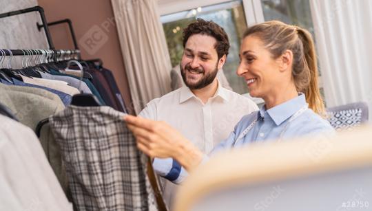 Tailor and client selecting a suit jacket from a rack in a wedding boutique  : Stock Photo or Stock Video Download rcfotostock photos, images and assets rcfotostock | RC Photo Stock.: