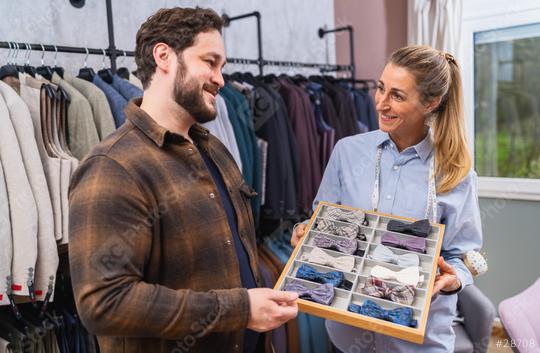 Tailor and customer smiling over a selection of bow ties in a clothing store  : Stock Photo or Stock Video Download rcfotostock photos, images and assets rcfotostock | RC Photo Stock.: