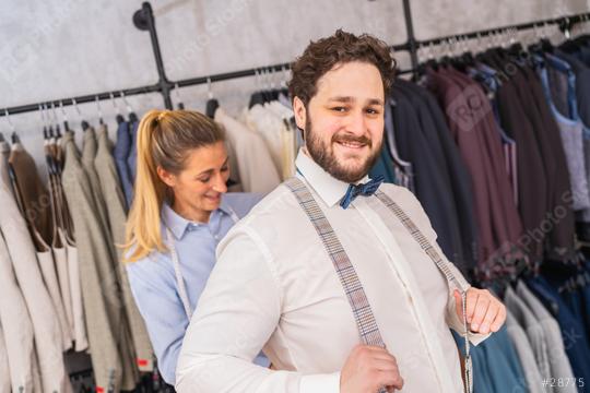 Tailor fastening a happy man