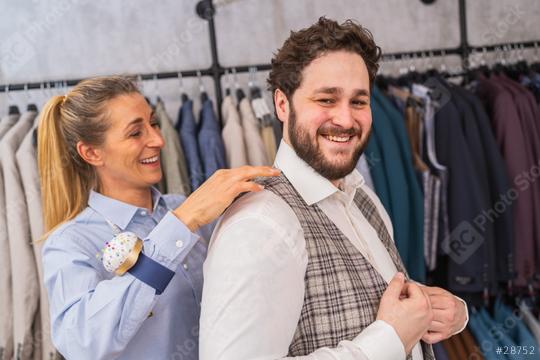 Tailor fitting a vest on a cheerful male client in a clothing store  : Stock Photo or Stock Video Download rcfotostock photos, images and assets rcfotostock | RC Photo Stock.: