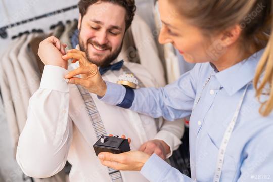 Tailor helping a man with cufflinks, both sharing a joyful moment
  : Stock Photo or Stock Video Download rcfotostock photos, images and assets rcfotostock | RC Photo Stock.: