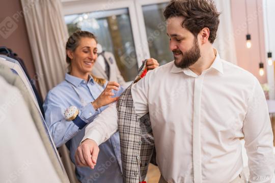 Tailor measuring a jacket on a client in a suit store  : Stock Photo or Stock Video Download rcfotostock photos, images and assets rcfotostock | RC Photo Stock.: