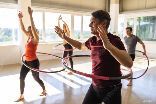 Team Sport women and men doing hula hoop in step waist hooping forward stance in fitness gym for healthy lifestyle concept.  : Stock Photo or Stock Video Download rcfotostock photos, images and assets rcfotostock | RC Photo Stock.: