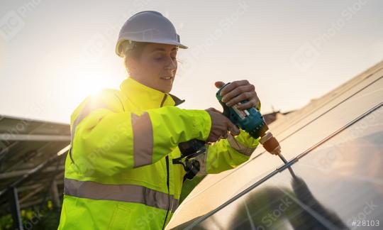 Technician assembling solar panels with a cordless drill at sunset. Alternative energy ecological concept image.  : Stock Photo or Stock Video Download rcfotostock photos, images and assets rcfotostock | RC Photo Stock.: