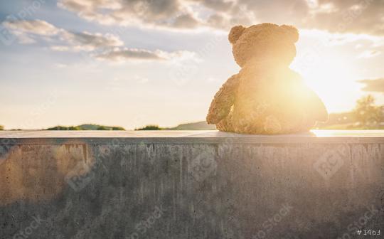 teddy bear sitting on a stone wall at sunset with cloudy sky, rear view. Love theme. Concept about love and relationship. copyspace for your individual text.  : Stock Photo or Stock Video Download rcfotostock photos, images and assets rcfotostock | RC Photo Stock.: