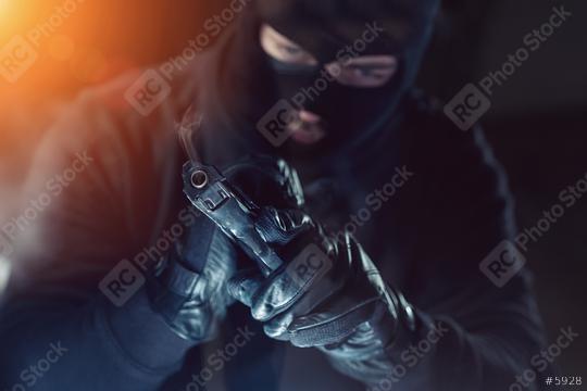 Terrorist or a thief holding a gun at night  : Stock Photo or Stock Video Download rcfotostock photos, images and assets rcfotostock | RC-Photo-Stock.: