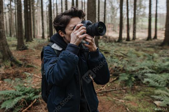 The photographer pay attention to take a photo in a beautiful forest. Adventure travel with camera in the nature.  : Stock Photo or Stock Video Download rcfotostock photos, images and assets rcfotostock | RC Photo Stock.: