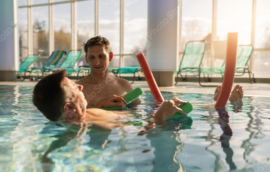 Therapist assisting patient with leg exercises using pool noodle  : Stock Photo or Stock Video Download rcfotostock photos, images and assets rcfotostock | RC Photo Stock.: