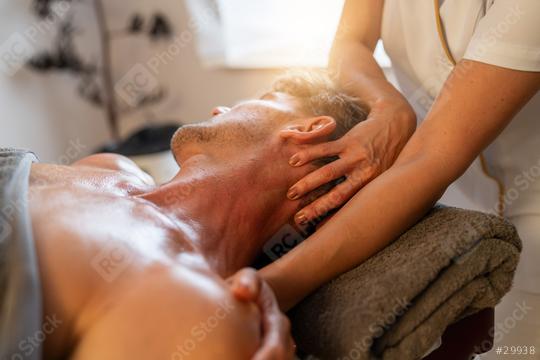 Therapist performing a neck massage on a male client in a spa setting: Wellness Hotel Concept image:  : Stock Photo or Stock Video Download rcfotostock photos, images and assets rcfotostock | RC Photo Stock.: