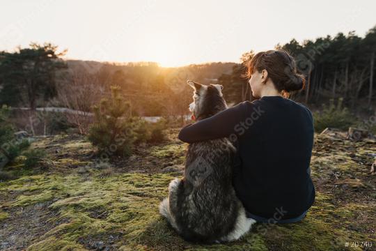 Thoughtful person and dog sit arm in arm in nature and look into the distance. The woman and the husky enjoy and relax during their trip.  : Stock Photo or Stock Video Download rcfotostock photos, images and assets rcfotostock | RC Photo Stock.:
