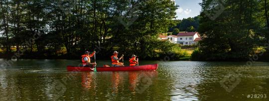 thre people in life jackets paddling a red canoe on a tranquil river with lush greenery in the background at summer in germany.  Family on kayak ride. Wild nature and water fun on summer vacation.  : Stock Photo or Stock Video Download rcfotostock photos, images and assets rcfotostock | RC Photo Stock.: