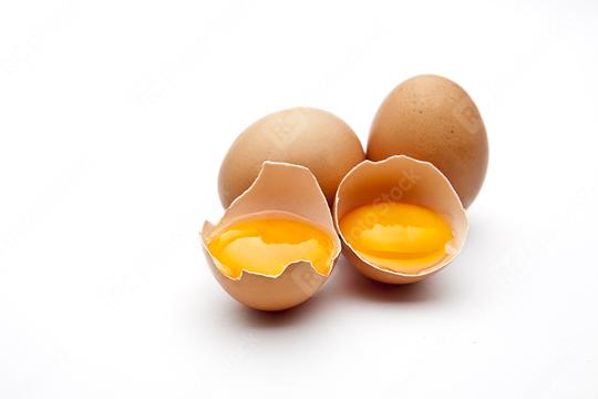 Three brown eggs are displayed on a white background, with two cracked open to reveal fresh, golden egg yolks inside their shells.  : Stock Photo or Stock Video Download rcfotostock photos, images and assets rcfotostock | RC Photo Stock.: