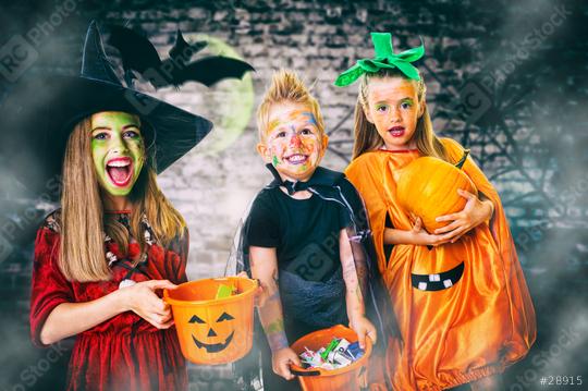 Three children dressed in Halloween costumes as a witch, pumpkin, and vampire, holding candy buckets and smiling in a spooky setting with bats, fog, and a glowing green moon in the background  : Stock Photo or Stock Video Download rcfotostock photos, images and assets rcfotostock | RC Photo Stock.: