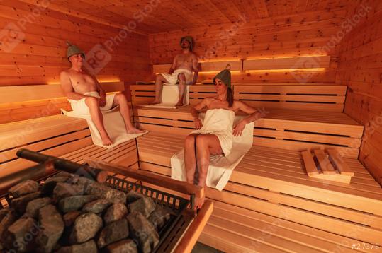 Three people in a sauna wearing finnish felt hats, two men seated and a woman reclining  : Stock Photo or Stock Video Download rcfotostock photos, images and assets rcfotostock | RC Photo Stock.: