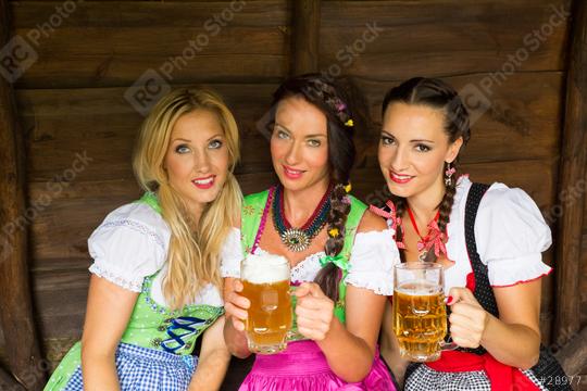 Three women dressed in traditional Bavarian dirndls hold beer mugs, smiling warmly in a cozy wooden setting, celebrating culture and friendship at an Oktoberfest or Bavarian-themed gathering.
  : Stock Photo or Stock Video Download rcfotostock photos, images and assets rcfotostock | RC Photo Stock.: